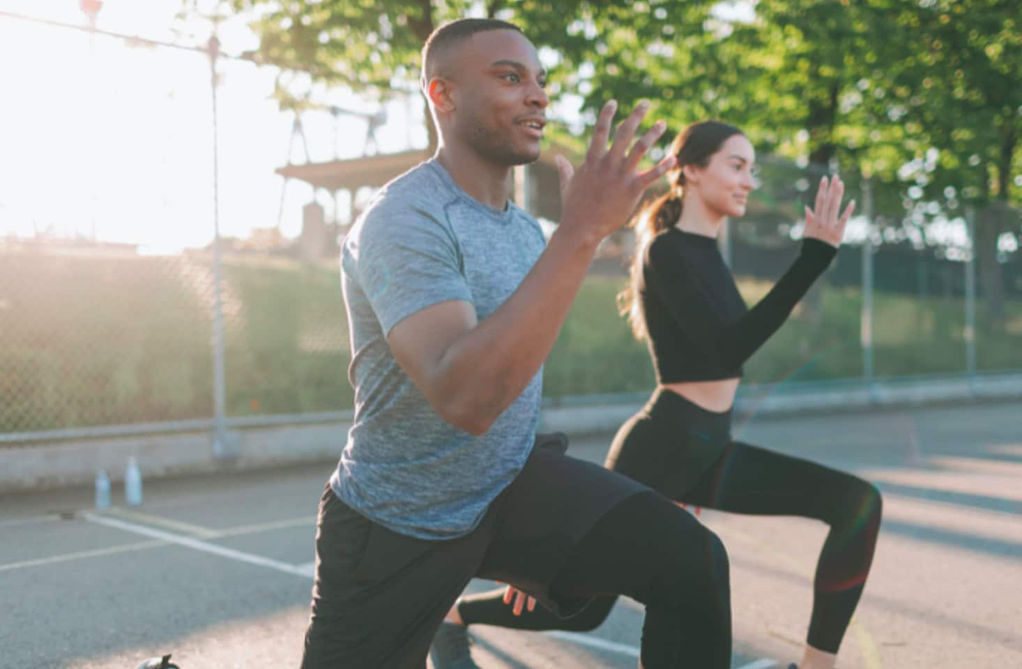 Man and woman exercising outdoors.